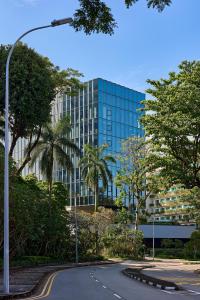 a glass building with a road in front of it at The Standard, Singapore in Singapore