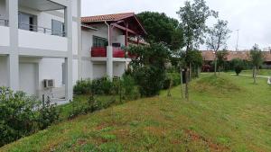 a house with a yard next to a building at location appartement in Soustons