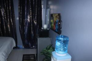a room with a bed and a tv in a room at The Loft & Found in Nairobi