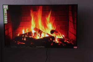 a fire in a fireplace with flames in it at The Loft & Found in Nairobi