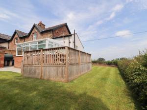 a wooden fence in front of a house at Rose Bank Cottage in Carlisle