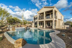 a house with a swimming pool in the yard at Pinnacle Perfection by Porter Heated Pool Spa w Outdoor Putting Green in Scottsdale