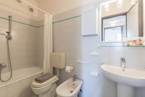 a white bathroom with a sink and a toilet at San Matteo Apartments in Loano +38 photos