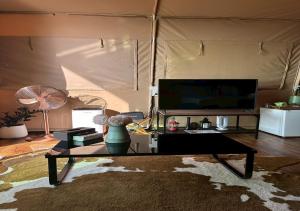 a living room with a table and a tv at Taara Montana Resort in Ban Huai Khai +17 photos