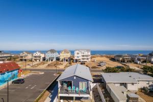 an aerial view of a residential neighborhood with the ocean at 5062 - Our Bright Idea in Kill Devil Hills