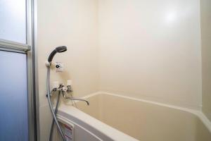 a shower in a bathroom with a bath tub at Silk Court 403 in Chitose