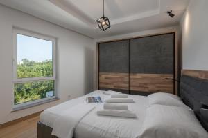a bedroom with a bed and a large window at Seaview Apartment Kostrena Two - Happy Rentals in Kostrena