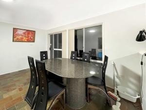 a dining room with a table and chairs at MetaWise Cozy Family Room in Shared Home Free Parking in Castle Hill