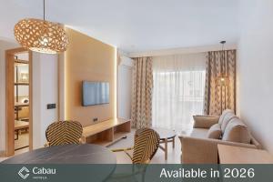 a living room with a couch and a table at Aparthotel Aquasol in Palmanova