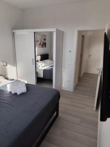 a bedroom with a bed and a room with a mirror at Maison 40 in Albiano