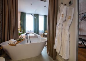 a bathroom with a bath tub in a room at Sennse Boutique Hotel in Sibiu +183 photos