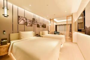 a bedroom with two beds in a room at Atour Hotel Beijing Fuxingmen in Beijing