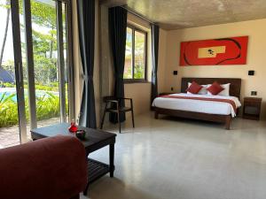 a bedroom with a bed and a couch and a table at Sea to Sea Villa Boutique in Hue +66 photos