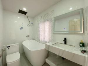 a white bathroom with a sink and a toilet at PAPAYA HOTEL & Café 2 in Ho Chi Minh City +46 photos