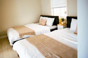 a bedroom with two beds and a window at Né Chill House in Ấp Khánh Phước (1) +3 photos