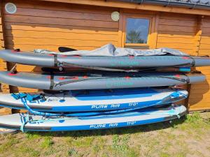 four kayaks are stacked on top of each other at Domek w Obozinie in Obozin