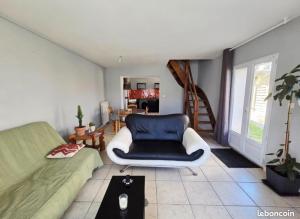 a living room with a couch and a chair at La Quarantaine in Quarante