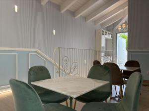 a dining room with a table and green chairs at Dimora Incanto in Giulianova