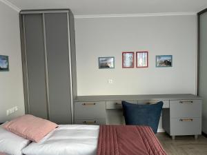 a bedroom with a bed and a desk at La Marina in Władysławowo +7 photos