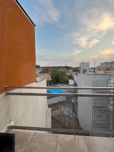 a balcony with a view of a swimming pool at La Marina in Władysławowo