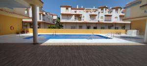 a swimming pool in the middle of a building at Alma de Zahara in Zahara de los Atunes