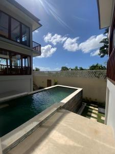 a swimming pool in the backyard of a house at SummerVille Nusa Dua by REJA Villas in Nusa Dua