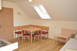 a dining room with a table and chairs and a skylight at Bauernhof Unterhöfner in Hof bei Salzburg