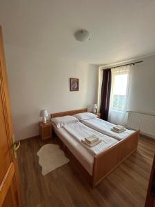 A bed or beds in a room at Penzión Nezábudka