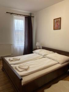 A bed or beds in a room at Penzión Nezábudka