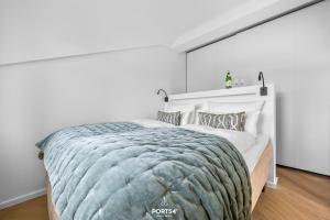 a bedroom with a large bed in a white room at Maybach Suite Westerland auf Sylt in Westerland