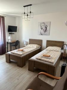 A bed or beds in a room at Penzión Nezábudka