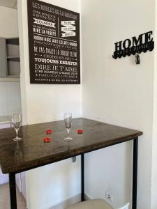 a bar with wine glasses and a sign on the wall at RAMI Appart in Antananarivo +18 photos