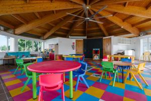 a classroom with colorful tables and chairs and a ceiling at AluaSun Mediterráneo in S'Algar