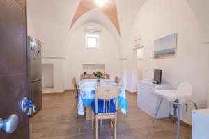een keuken en eetkamer met een tafel en een koelkast bij Villa della Nonna in Torre Canne