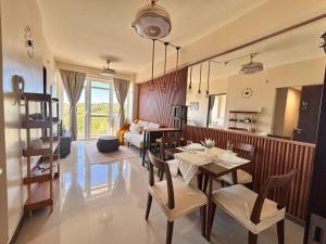a dining room with a table and chairs and a couch at Twin AJ Boracay in Boracay