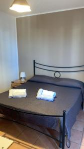 a bedroom with a bed with two towels on it at Home Fiesta in Giardini Naxos