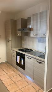a kitchen with a stove and a sink at Home Fiesta in Giardini Naxos