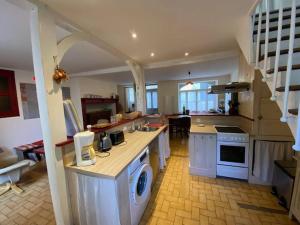a large kitchen with a sink and a stove at Jolie maison de vacances centre Gramat in Gramat