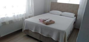 a bedroom with a bed with two towels on it at GEYİKLİ BULUT Pansiyon in Ezine