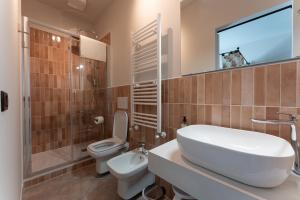 a bathroom with a sink and a toilet and a shower at Tenuta Tre Gemme in Cantina- Renascenzia SantIrene in Catignano