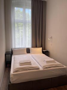 a bed in a bedroom with a large window at Motel Blue - Minimalist Boutique Hotel in Berlin