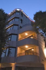 a tall building with balconies on the side of it at Hotel Divesta in Varna City