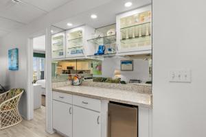 a kitchen with white cabinets and a counter top at Edgewater Condo Unit #303 Apts in South Padre Island