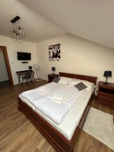 A bed or beds in a room at Penzión Nezábudka