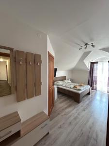 A bed or beds in a room at Penzión Nezábudka