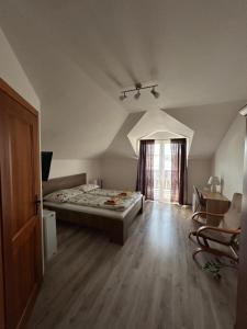 A bed or beds in a room at Penzión Nezábudka