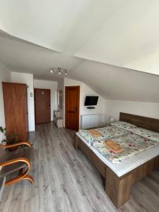 A bed or beds in a room at Penzión Nezábudka