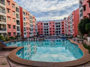 a large swimming pool in a city with buildings at Traveler's Nest near Airport, Netflix, Stylish, Cozy with swimming pool in Lapu Lapu City