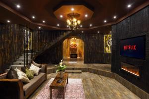a living room with a couch and a television at The Edgware Cabana in Nuwara Eliya