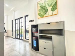 a room with a large metal entertainment center at wendy syariah mansion in Gandul